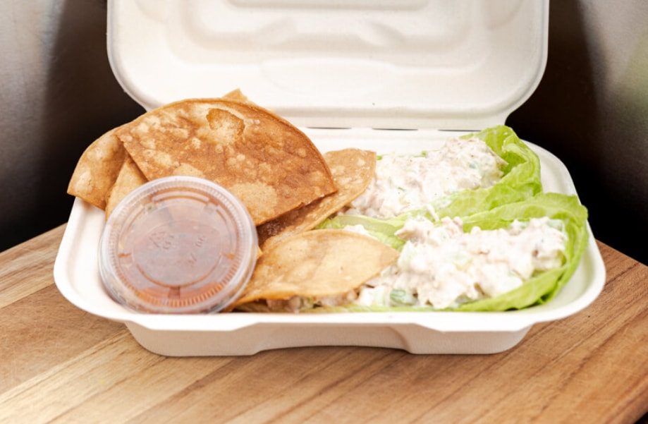 Tacos in a compostable container with dipping sauce