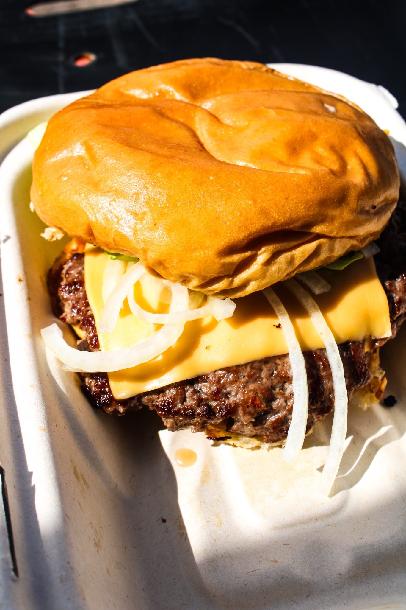 Smash burger with melted cheese on a brioche bun