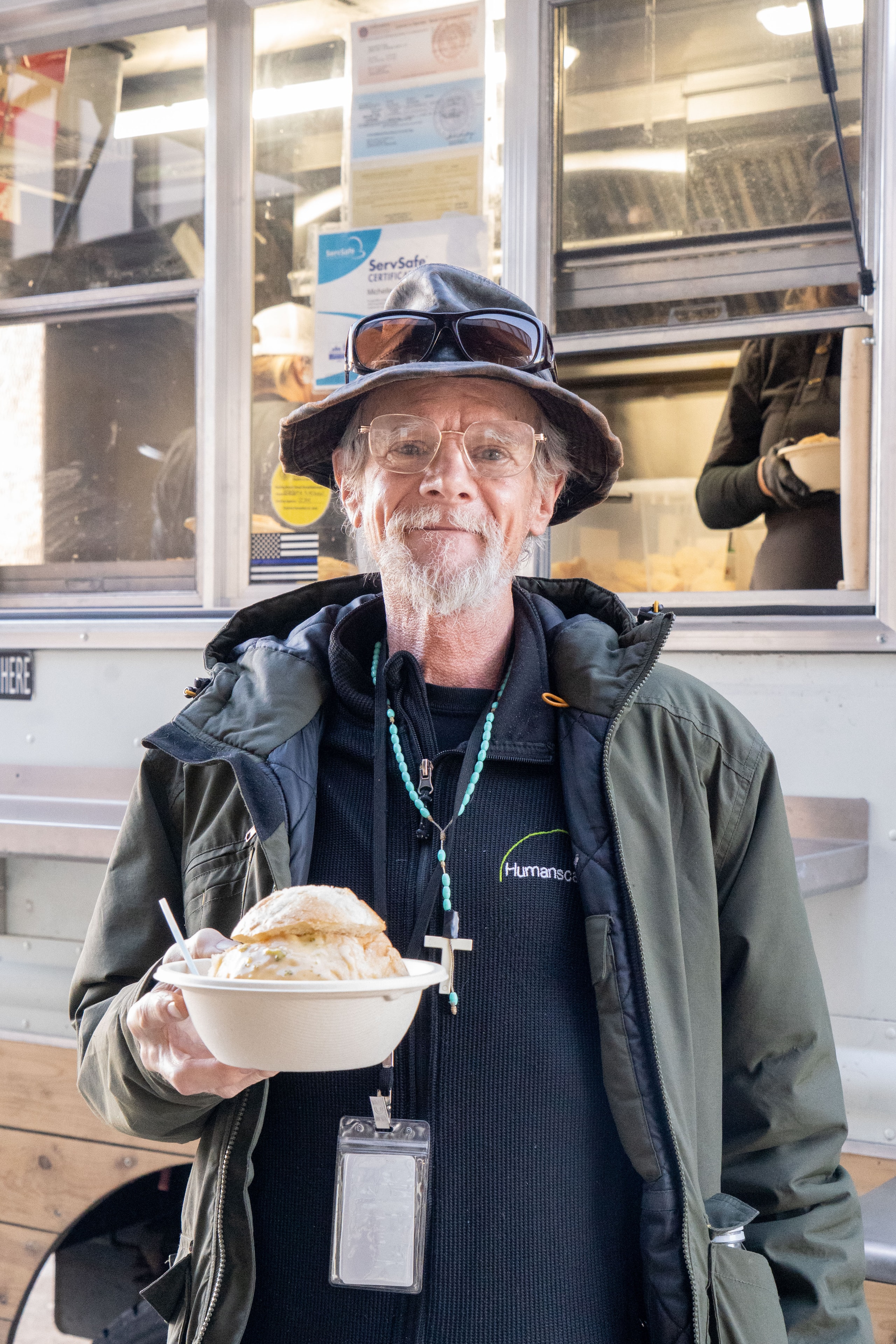 Customer with a bread bowl at the Revolver Kitchen truck