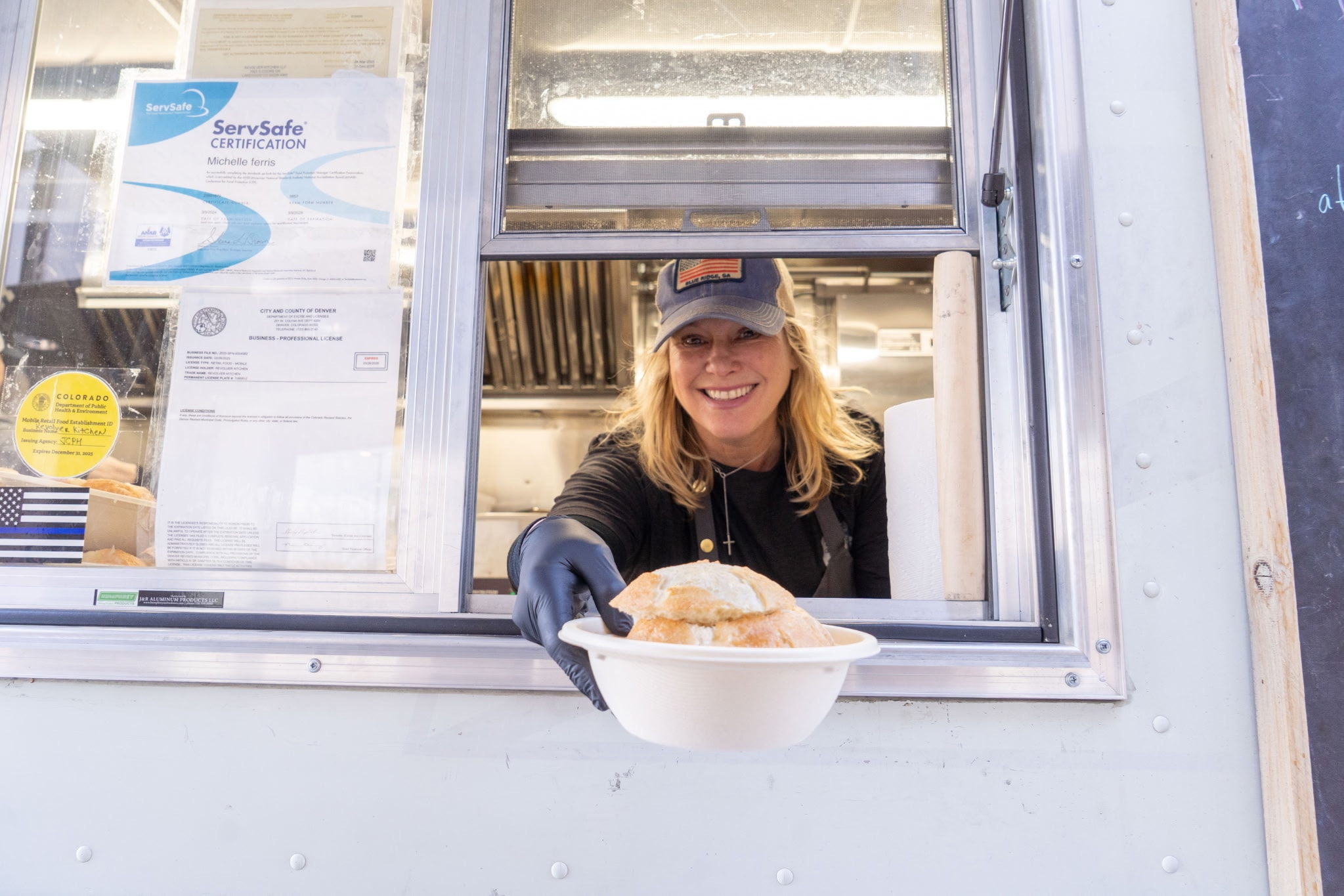 Michelle smiling at the Revolver Kitchen service window