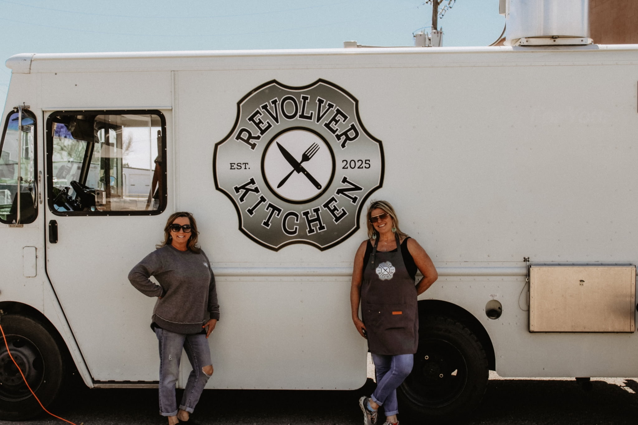Shannon and Michelle standing in front of the Revolver Kitchen truck