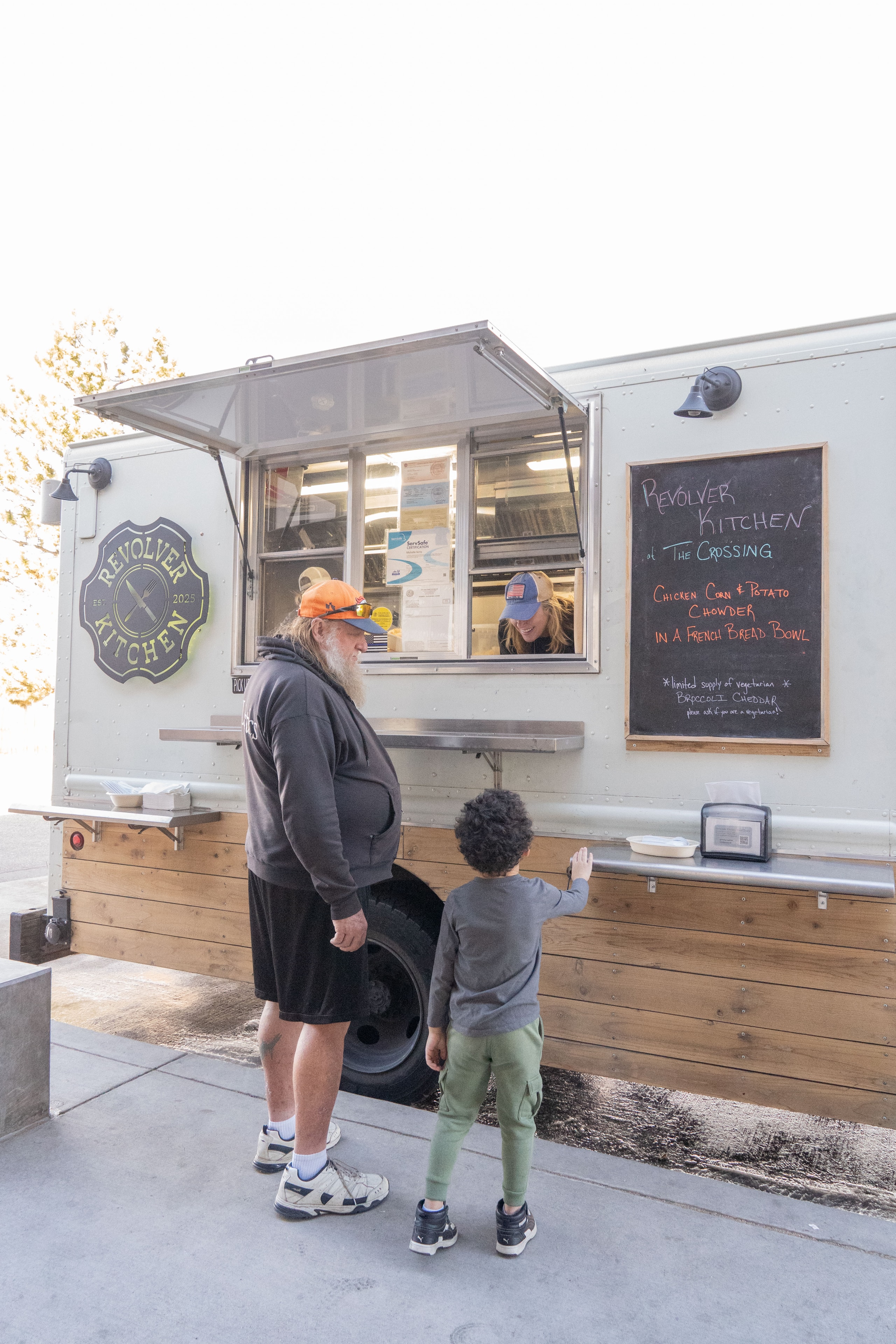 Customer with food at the Revolver Kitchen truck