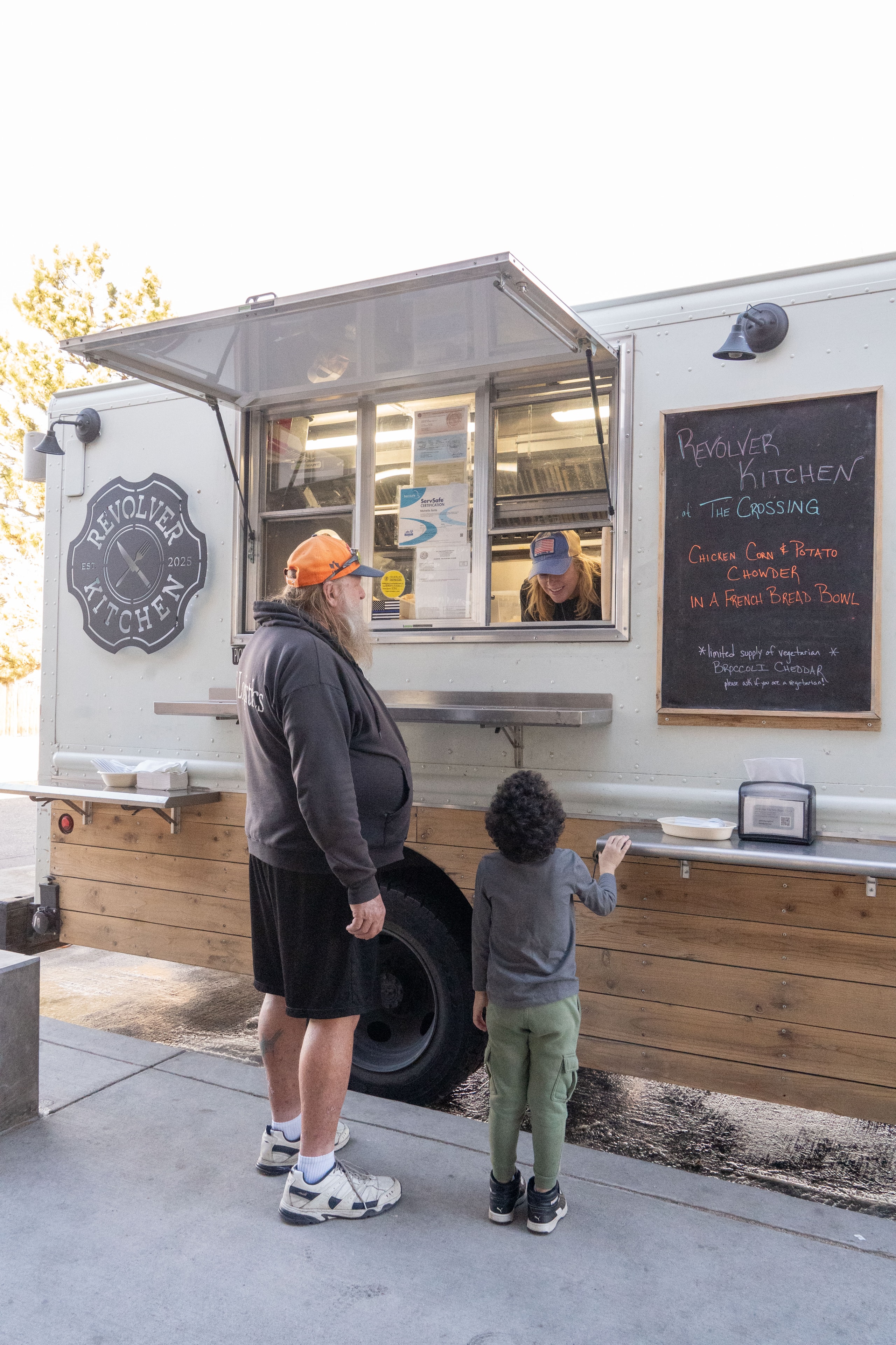 Happy customer smiling at the Revolver Kitchen window