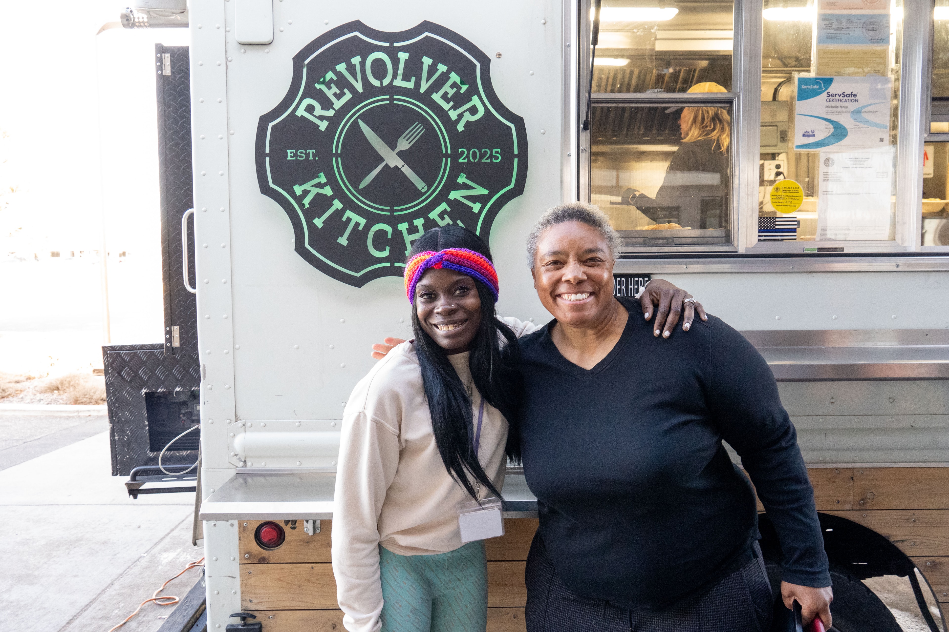 Two people at the Revolver Kitchen food truck
